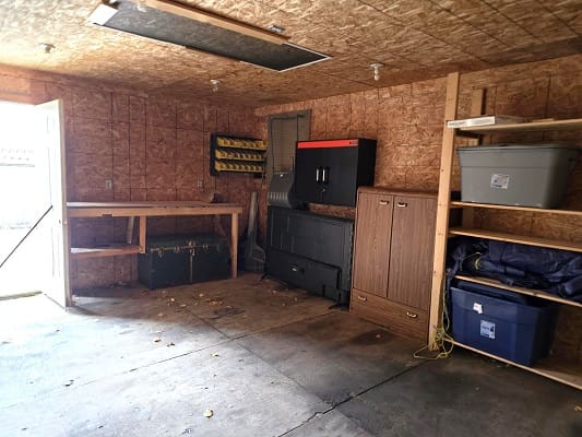 Garage interior with shelves and workbench.