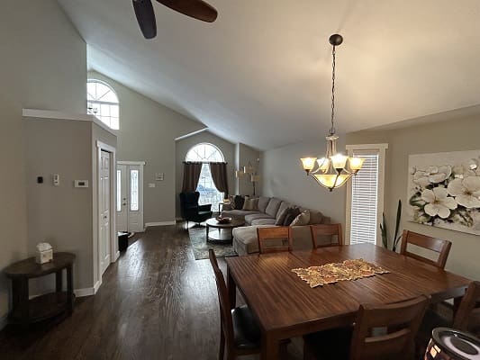Modern living and dining room with chandelier.