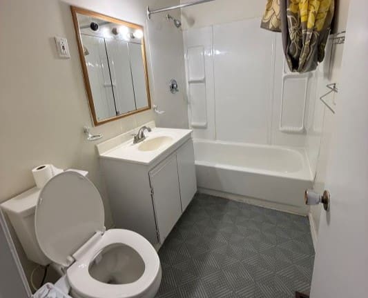 Small bathroom with bathtub and vanity sink.