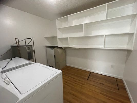 Laundry room with shelves and appliances.