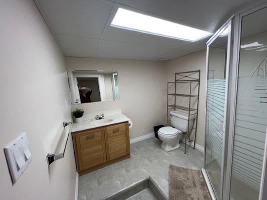 Modern bathroom with shower and vanity unit.