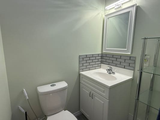 Small bathroom with sink and toilet.