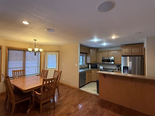 Open kitchen and dining area with table.