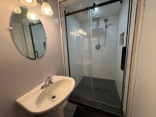 Modern bathroom with shower and sink.