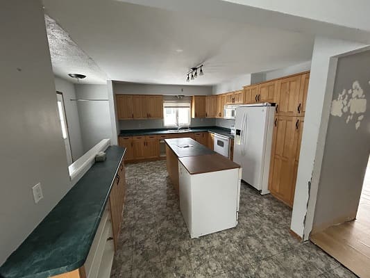 Spacious kitchen with island and appliances.