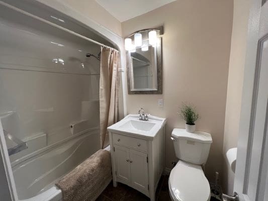 Small modern bathroom with white fixtures.