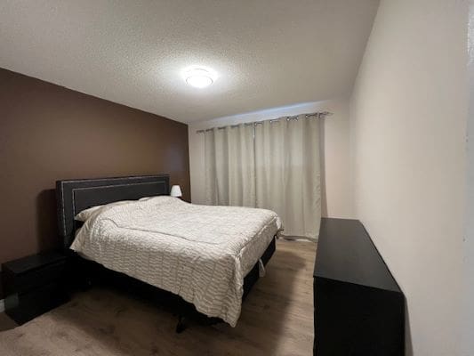 Minimalist bedroom with bed and curtains.