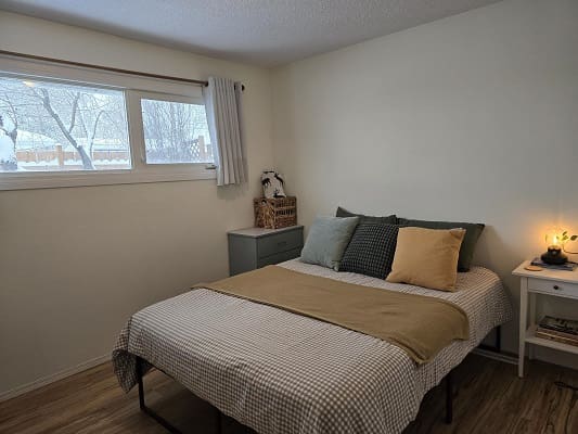 Cozy bedroom with window and simple decor.