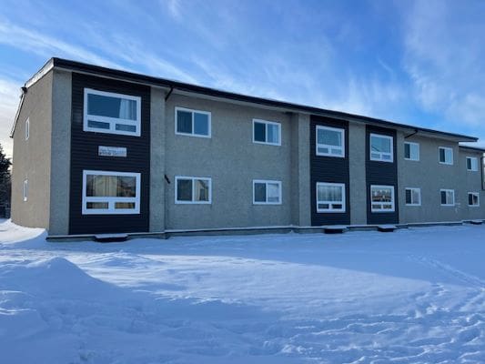 Two-story building in snowy landscape.