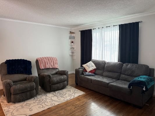 Living room with chairs and a sofa.