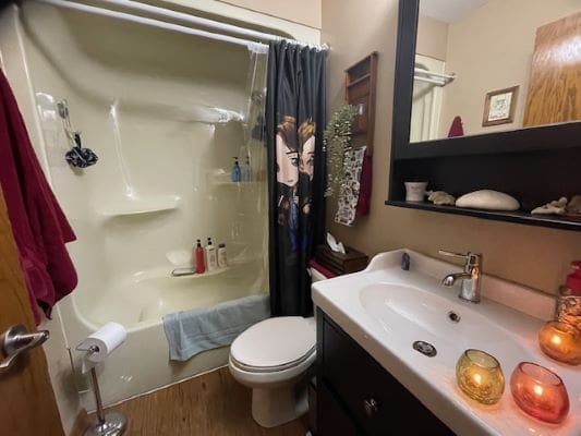 Bathroom with shower, sink, and decorative candles.