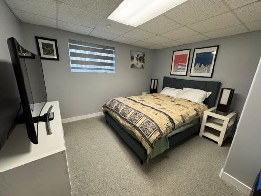 Modern bedroom with bed and wall art.