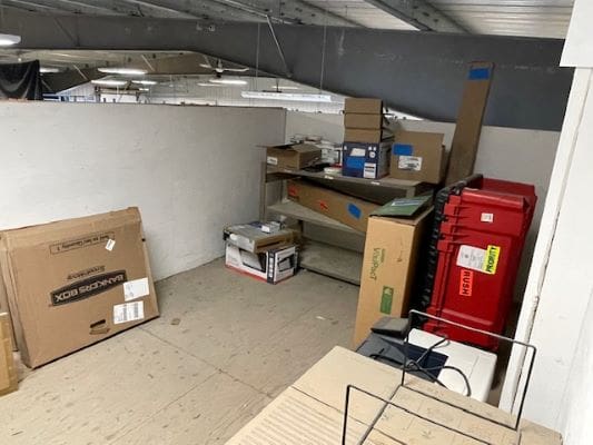 Storage area with boxes and shelves.