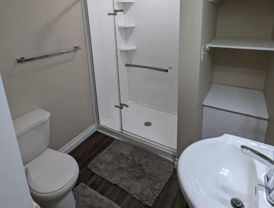Small bathroom with shower and toilet.