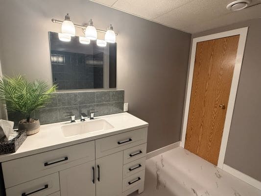 Modern bathroom with vanity and mirror.