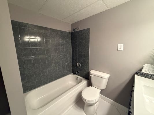 Bathroom with bathtub, toilet, and sink.