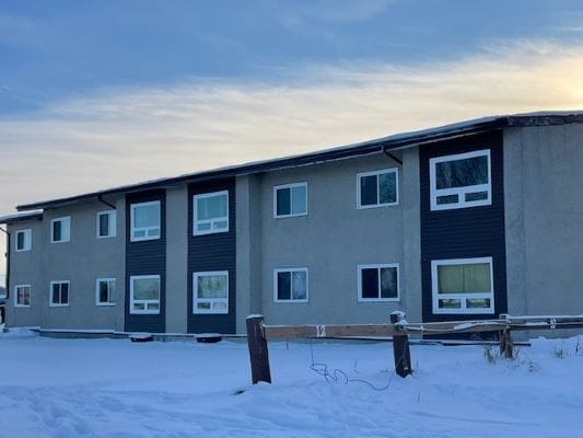 Two-story building with snowy surroundings.