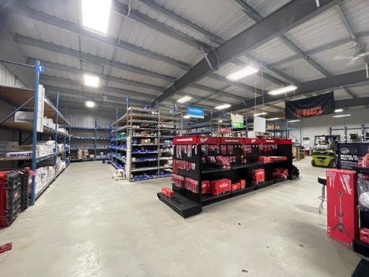 Warehouse with shelves and tools on display.