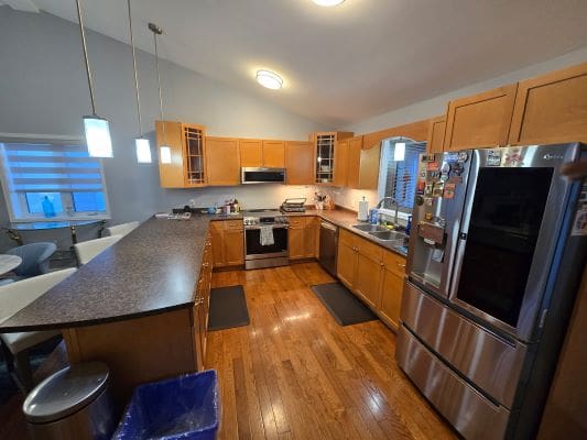 Modern kitchen with wooden cabinets and appliances.