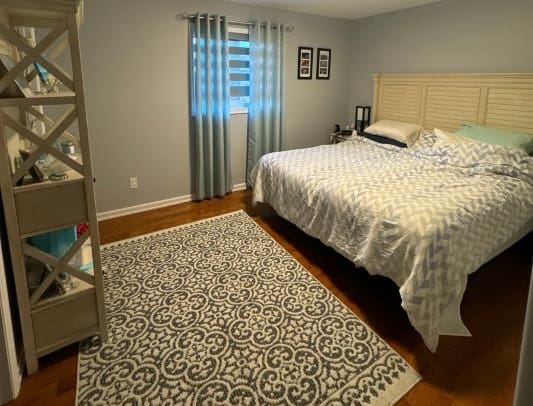 Cozy bedroom with patterned rug and bed.
