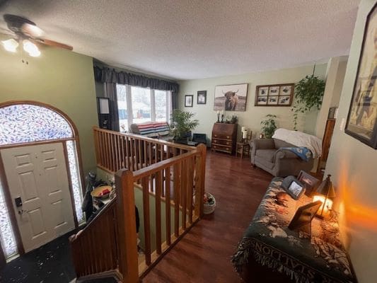 Cozy living room with wooden staircase.