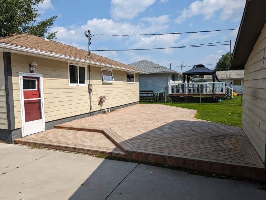 Backyard with wooden deck and gazebo.
