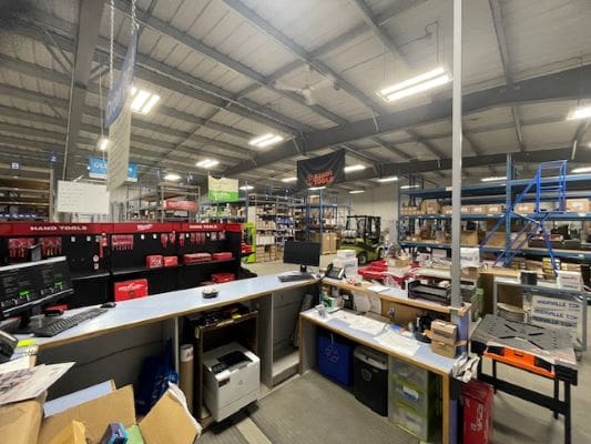 Warehouse interior with shelves and counters.