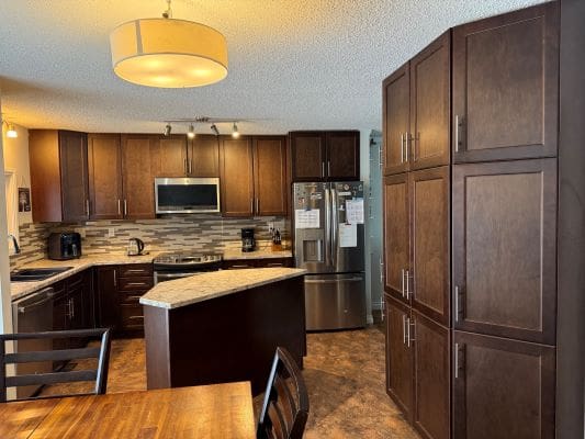 Modern kitchen with dark wood cabinets.