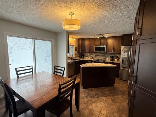 Modern kitchen with dining table and chairs.