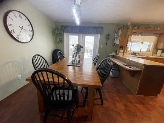 Dining room with table and large clock.