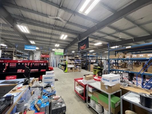 Warehouse interior with shelves and various items.