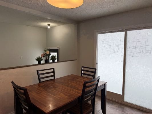 Dining room with wooden table and chairs.