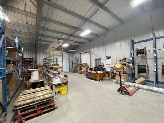 Warehouse with shelves and industrial equipment.