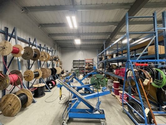 Industrial warehouse with cables and equipment.