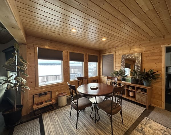 Cozy wooden dining room with round table.
