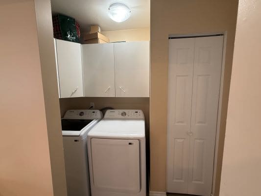 Laundry room with washer and dryer units.