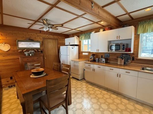 Cozy wooden kitchen with dining area.
