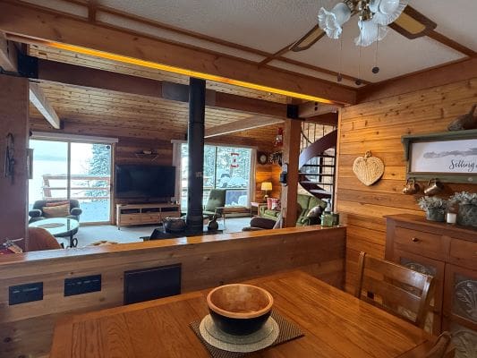 Cozy wooden cabin interior with spiral staircase.