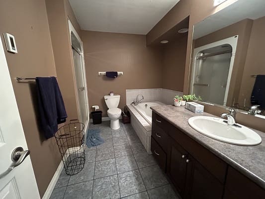 Modern bathroom with tub and shower area.