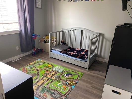Child's room with bed and play mat.
