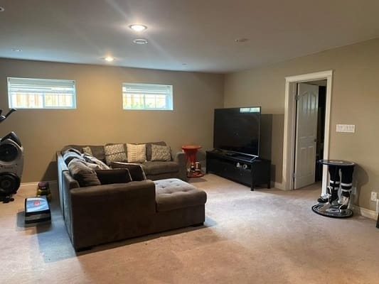 Basement living room with sectional sofa.