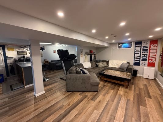 Basement recreation room with sectional sofa.