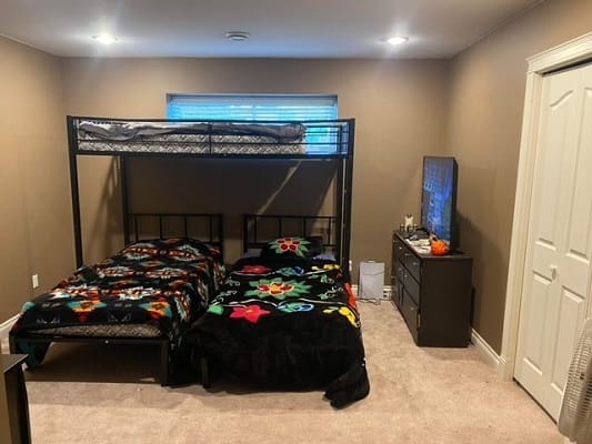 Bedroom with bunk bed and dresser.