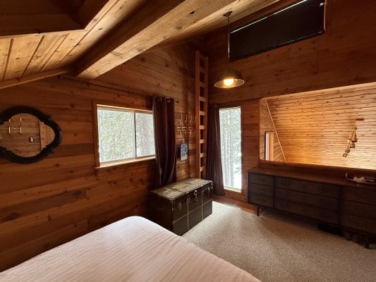 Cozy wooden bedroom with natural light.