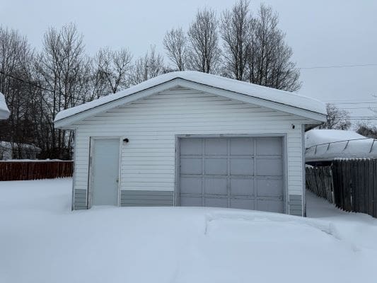 Snow-covered garage on a winter day.