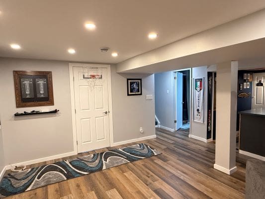 Basement room with wooden floor and decor.
