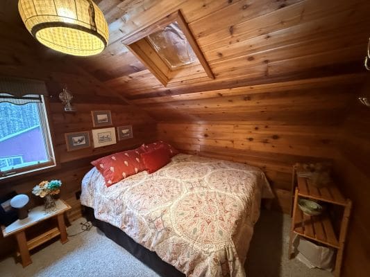 Cozy attic bedroom with wooden walls.