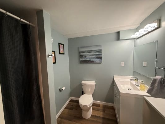 Modern bathroom with shower and vanity sink.