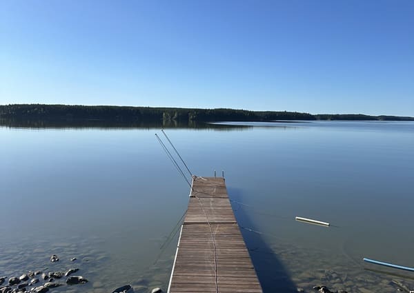 Calm lake with wooden fishing dock.