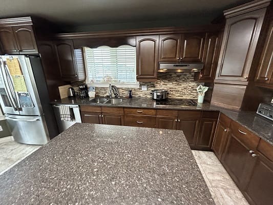 Modern kitchen with dark wood cabinets.